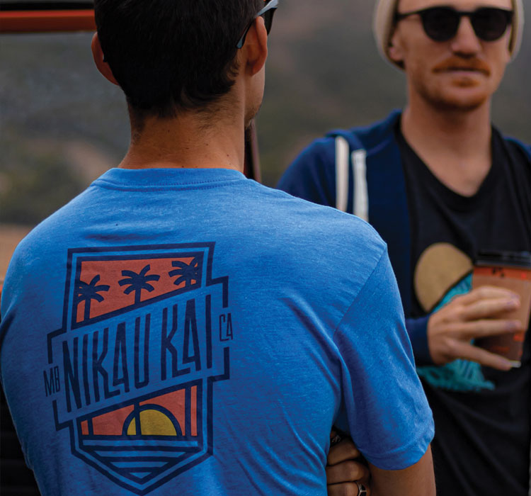 Back view of blue t-shirt with Nikau Kai logo