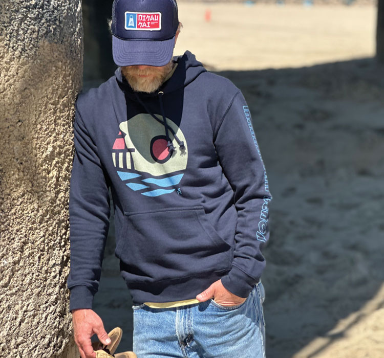 Navy hoodie with geometric wave design near pier