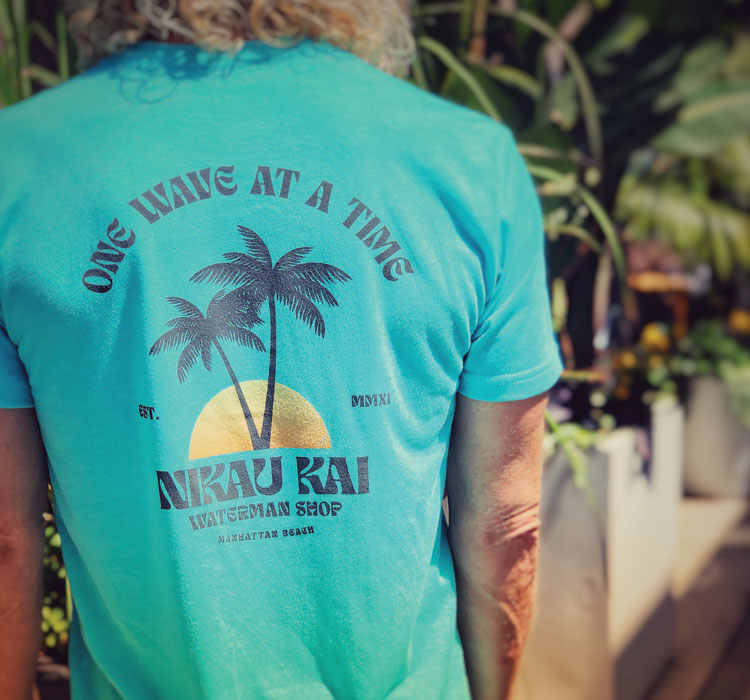 Back of teal tee with ONE WAVE AT A TIME design