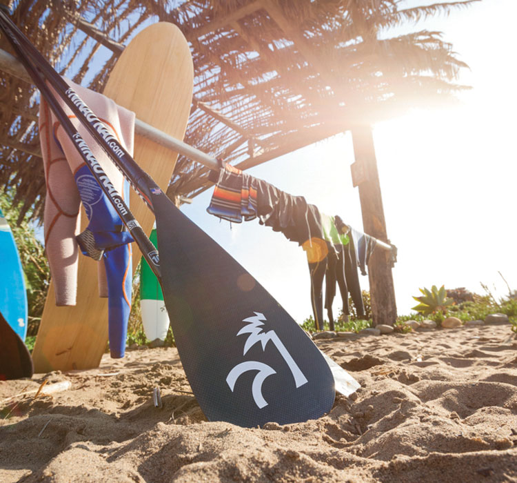 Paddle with Nikau Kai logo stuck in sand